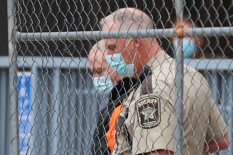 Former Minneapolis police officer Derek Chauvin is escorted from the rear of the Hennepin County Family Justice Center: AP