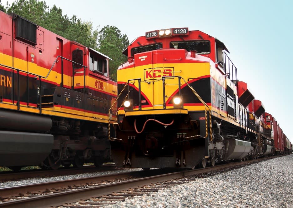 Two Kansas City Southern locomotives pass each other.