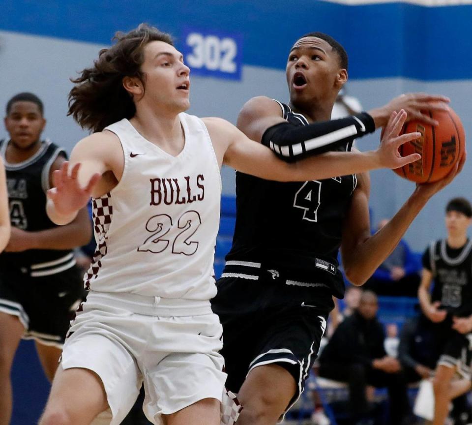 Bridgeport point guard Marcus Delgado (22) fouls YMLA’s D’Monyae Davis (4) during a 4A Region 1 bi-district basketball game at Brewer High School in Fort Worth, Texas, Monday, Feb. 22, 2021. YMLA led by 12 at the half way mark. (Special to the Star-Telegram Bob Booth)