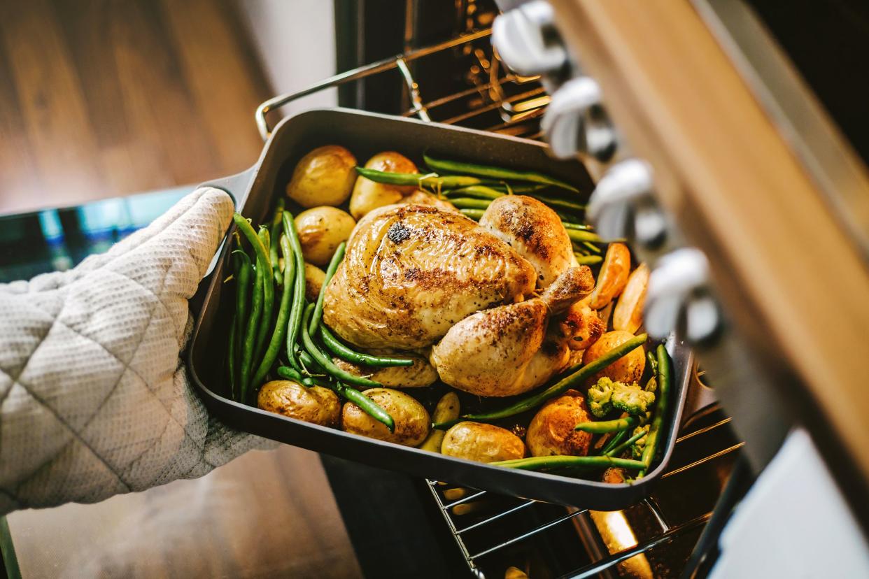 Taking roast chicken out of the oven