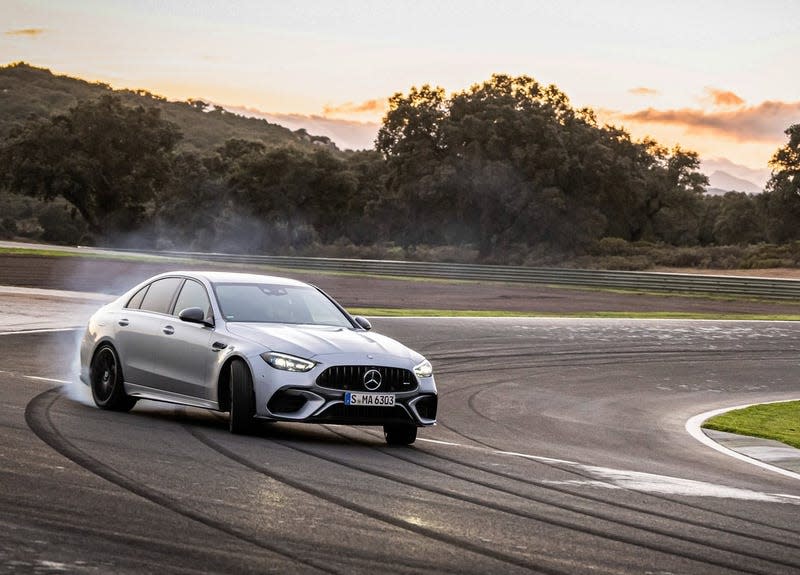 A Mercedes-Benz C63S AMG E-Performance sliding around a racetrack corner