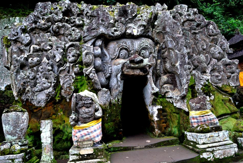 <b>Goa Gajah temple in Bali, Indonesia</b><br><br>Goa, I learned, is pronounced “Guha” as in many Indian languages. It refers to a 1,000-year-old cave excavated here that houses the Hindu trinity of gods and Ganesha, whom the Balinese know as “Gajah” (as in elephant). The 11th century site, called Lwa Gajah, was not discovered until the 1950s and was believed to be a sanctuary of a Buddhist monk. Carved images of the Buddha and smaller shrines and a step-well dot the green landscape here.