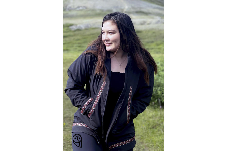 This undated photo shows Sara Bioff wearing an Atmik, a water-proof garment made by her mother, Alice Bioff, that resembles the traditional Alaska Native garment called a kuspuk in Nome, Alaska. The garment was inspired by a tourist Alice Bioff met in 2016 when she was a tour guide, and she hopes the $600 million expansion of the Port of Nome will translate into support of Nome stores and Indigenous artists. (Alice Bioff via AP)