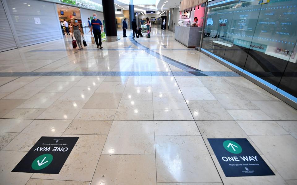 Social distancing signs are seen in a shopping centre in Canary Wharf, following the outbreak of the coronavirus disease (COVID-19), London, Britain, May 27, 2020. REUTERS/Dylan Martinez - Reuters