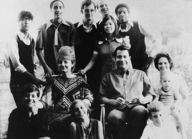 <p>Don Hogan Charles/New York Times Co./Getty </p> Jim Jones and Marceline Jones with their adopted children and next to his sister-in-law with her three children in 1976.