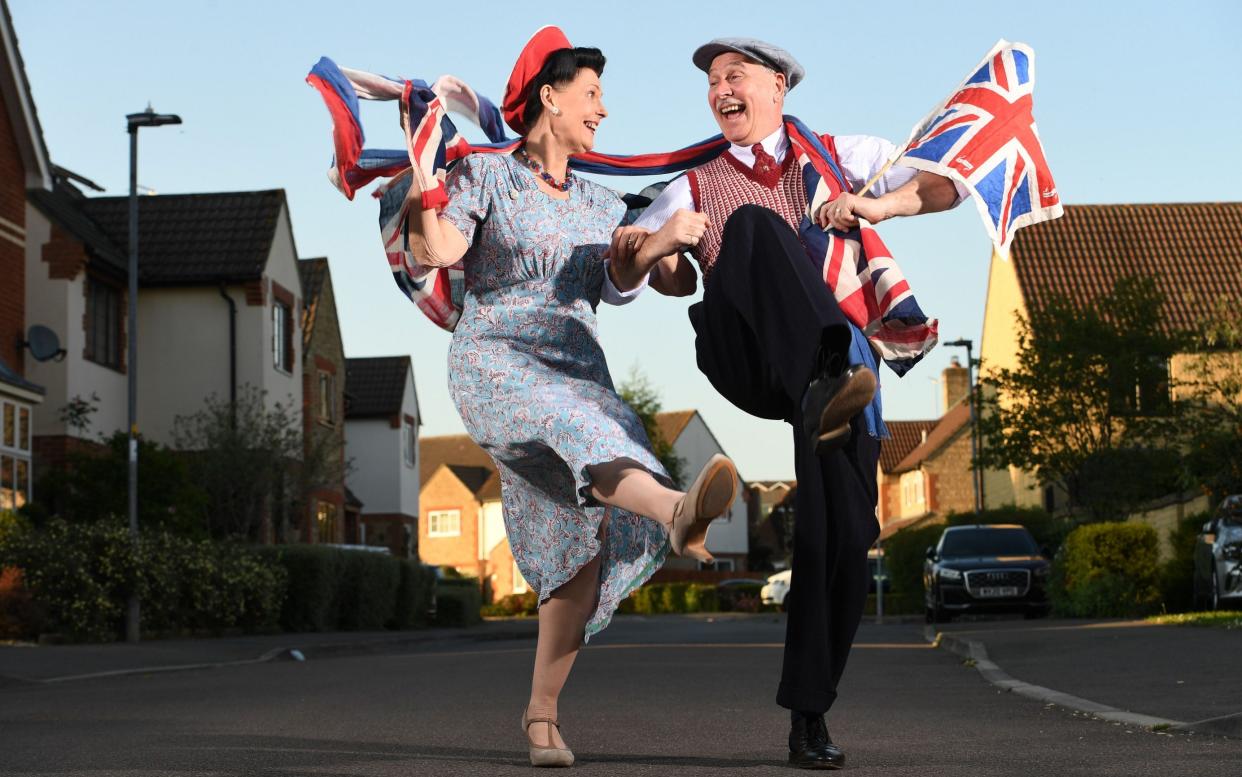 George and Kate Luck dance outside their home in Chippenham - RUSSELL SACH