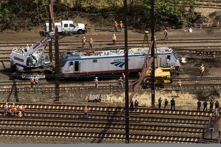 Emergency workers inspect the engine of a derailed Amtrak train in Philadelphia, Pennsylvania May 13, 2015. REUTERS/Lucas Jackson