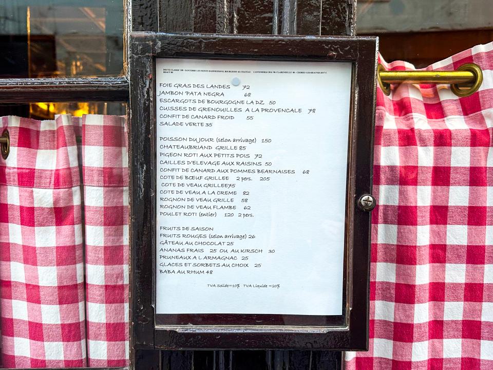 Menu outside of L'Ami Louis in frame 