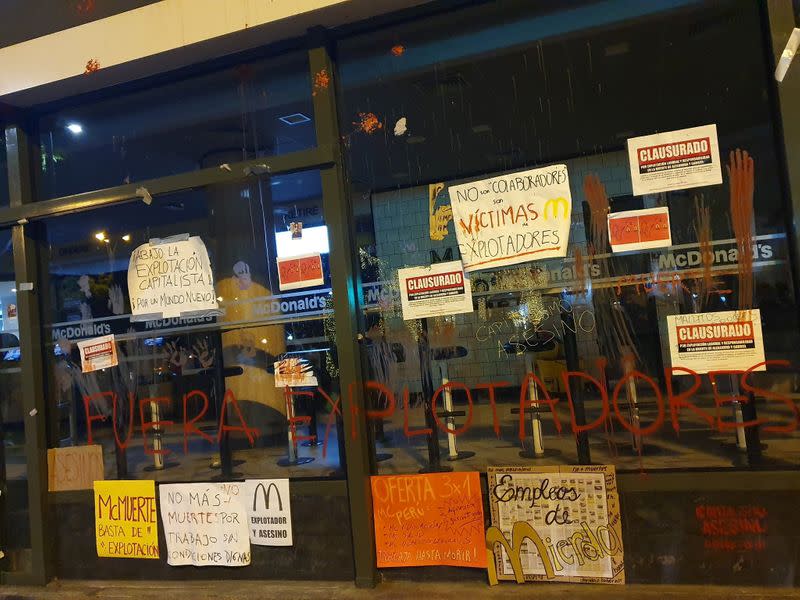 Protest signs are seen outside of a closed McDonald's restaurant, in Miraflores near Lima