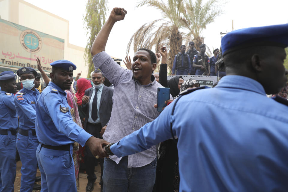 Family members of ousted Sudanese President Omar al-Bashir and over two dozen top officials in his government, protest outside a courthouse where they are on trial, in Khartoum, Sudan, Tuesday, July 21, 2020. The 76-year-old al-Bashir has been jailed in Khartoum since his ouster, facing several separate trials related to his rule and the uprising that helped oust him. Al-Bashir is also wanted by the International Criminal Court on charges of war crimes and genocide linked to the Darfur conflict in the 2000s. (AP Photo/Marwan Ali)