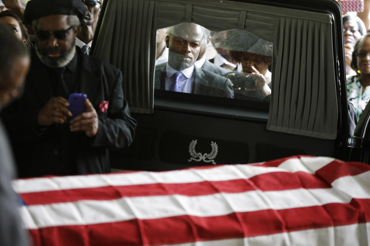 Mourners look on as the casket of Walter Scott is removed from a hearse for his funeral at W.O.R.D. Ministries Christian Center, Saturday, April 11, 2015, in Summerville, S.C. Scott was killed by a North Charleston police officer after a traffic Saturday, April 4, 2015. (David Goldman/Getty Images)