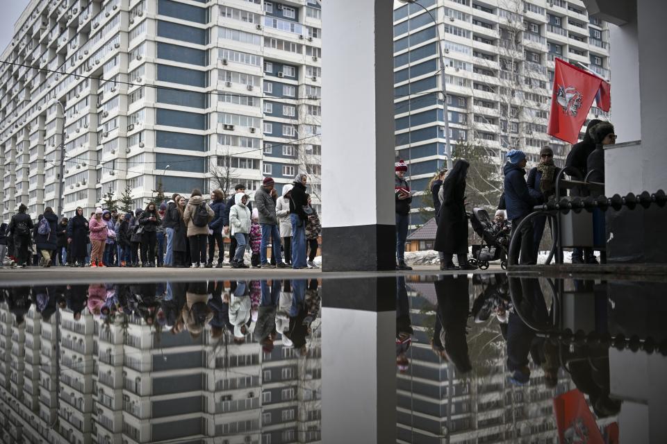 Voters queue at a polling station at noon local time in Moscow, Russia, on Sunday, March 17, 2024. The Russian opposition has called on people to head to polling stations at noon on Sunday in protest as voting takes place on the last day of a presidential election that is all but certain to extend President Vladimir Putin's rule after he clamped down on dissent. AP can't confirm that all the voters seen at the polling station at noon were taking part in the opposition protest. (AP Photo)