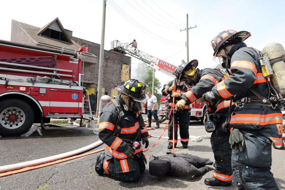 Yonkers firefighters remove a victim during a structure fire drill at the Westchester County Fire Training Center in Valhalla June 21, 2023. Trainings are done to keep firefighters up to date on new practices, to work on deficiencies and to test new equipment.