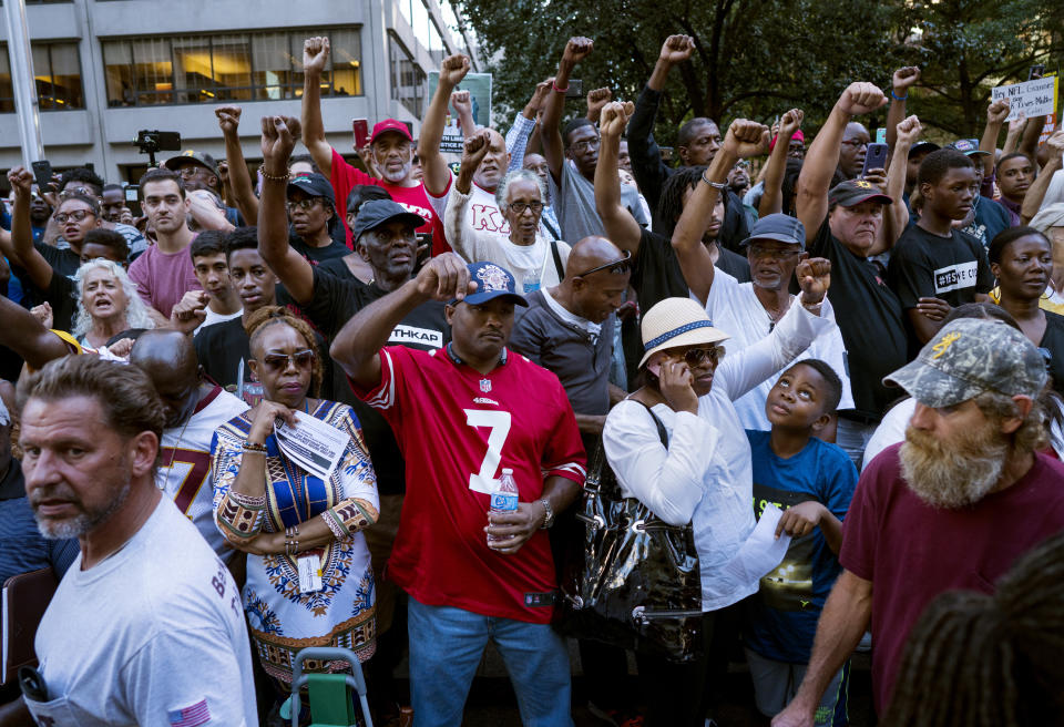 Supporters of unsigned NFL quarterback Colin Kaepernick mingle with passers-by on the sidewalk on Wednesday in New York. (AP)