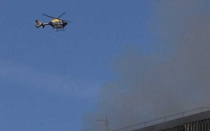 A police helicopter pictured above Grenfell Tower on the day of the fire