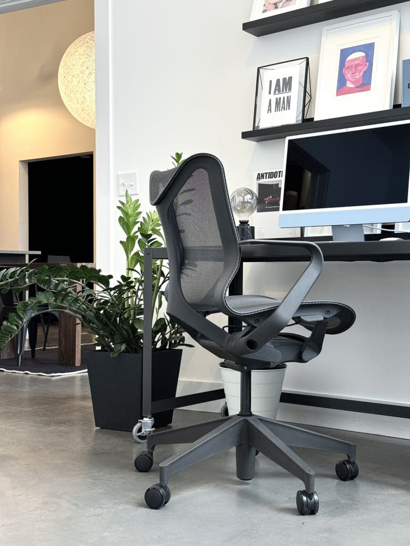 Black office chair and desk with blue iMac.