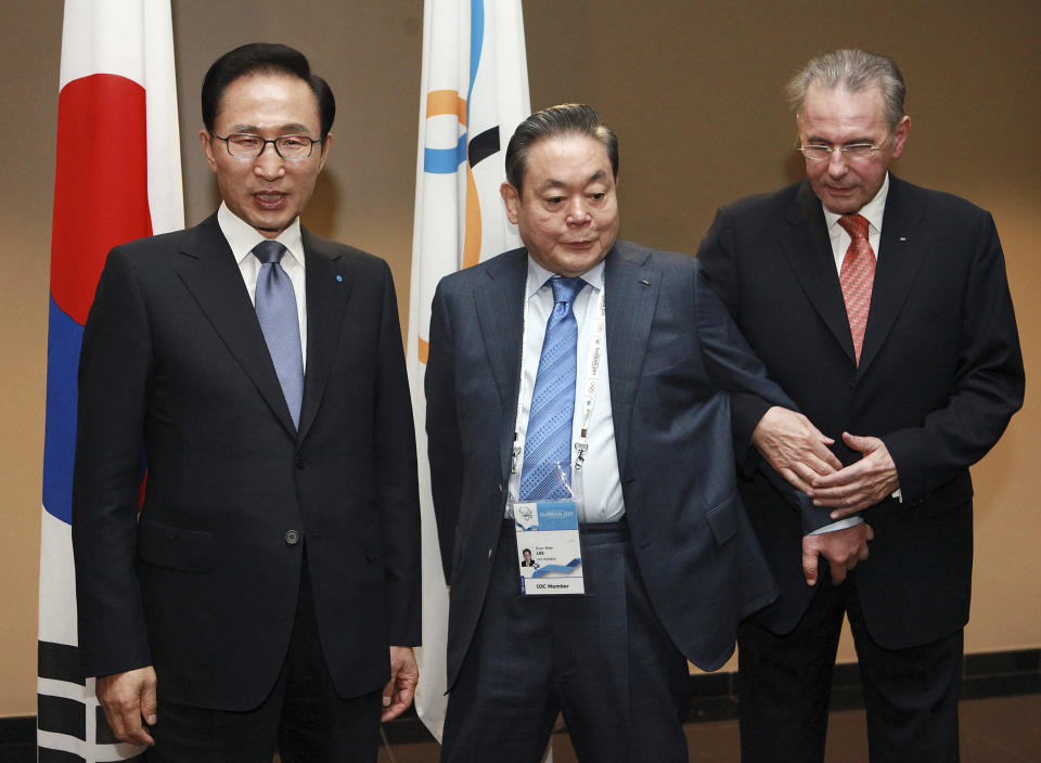 FILE - In this July 5, 2011, file photo, President of the International Olympic Committee (IOC) Jacques Rogge, right, meets with South Korean President Lee Myung-bak, left, and Samsung Chairman Lee Kun-hee in Durban, South Africa, ahead the opening ceremony for the 123rd IOC session that would decide the host city for the 2018 Olympics Winter Games. Lee, the ailing Samsung Electronics chairman who transformed the small television maker into a global giant of consumer electronics, has died, a Samsung statement said Sunday, Oct. 25, 2020. He was 78. (AP Photo/Rajesh Jantilal-Pool, Pool, File)