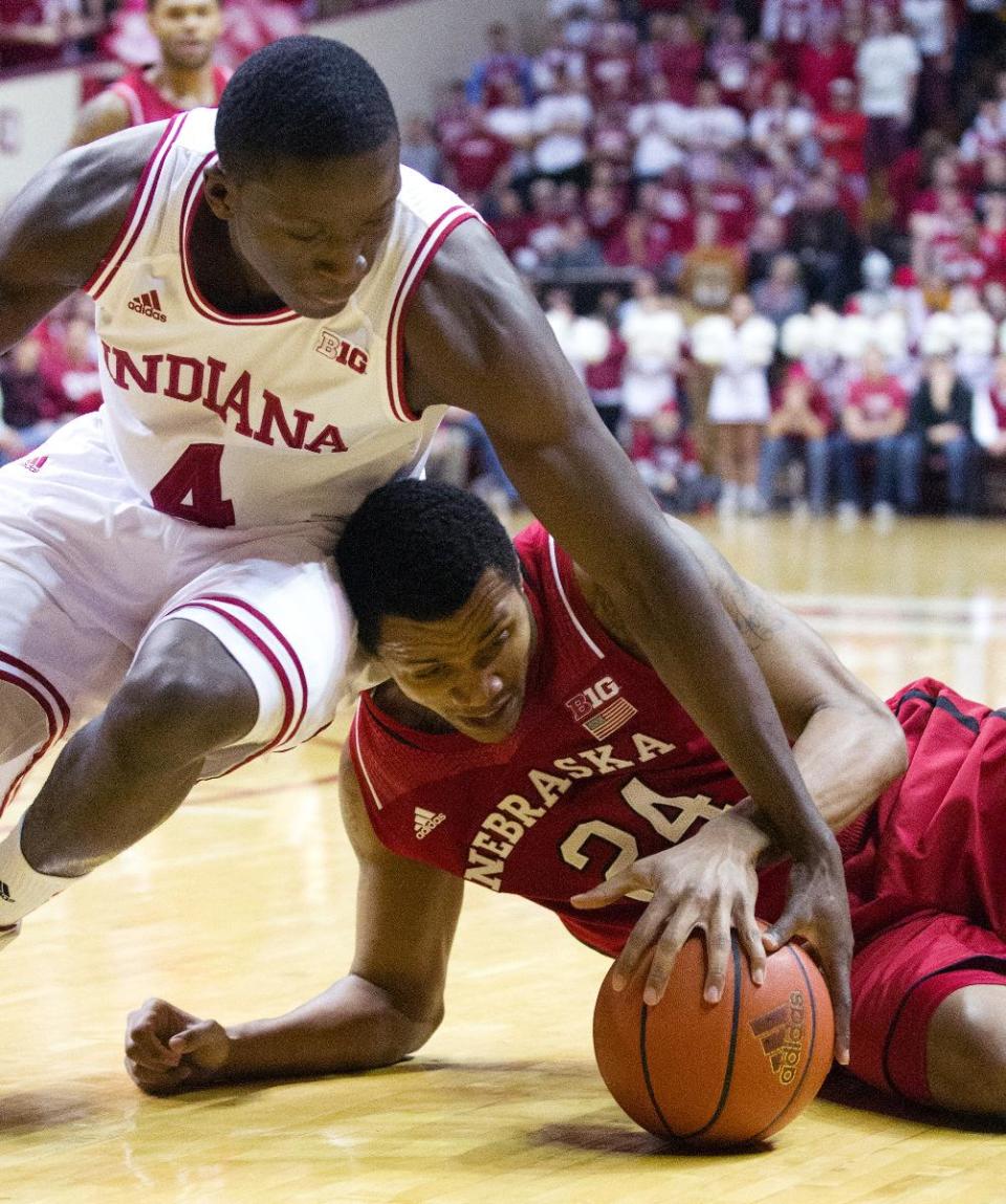 Nebraska's Dylan Talley (24) and Indiana's Victor Oladipo (4) battle for a loose ball during the first half of an NCAA college basketball game, Wednesday, Feb. 13, 2013, in Bloomington, Ind. (AP Photo/Doug McSchooler)