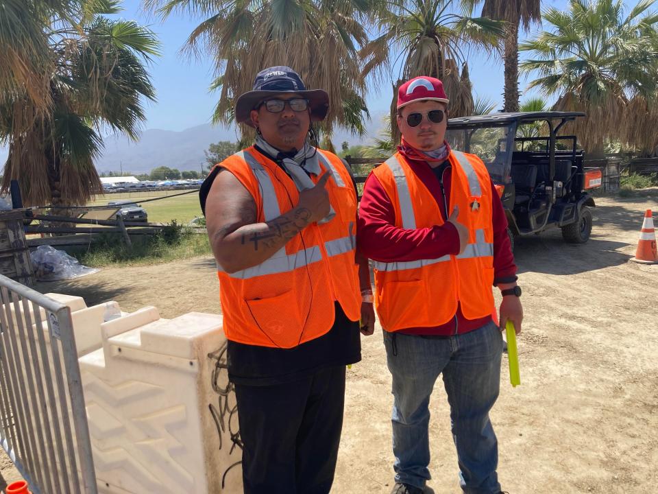 Carlos Chavez and Kenneth Carleton are working at the Coachella Valley Music and Arts Festival to guide traffic. They donate their earnings to their church.