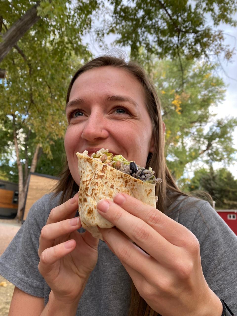 The author eating a veggie Qdoba burrito.