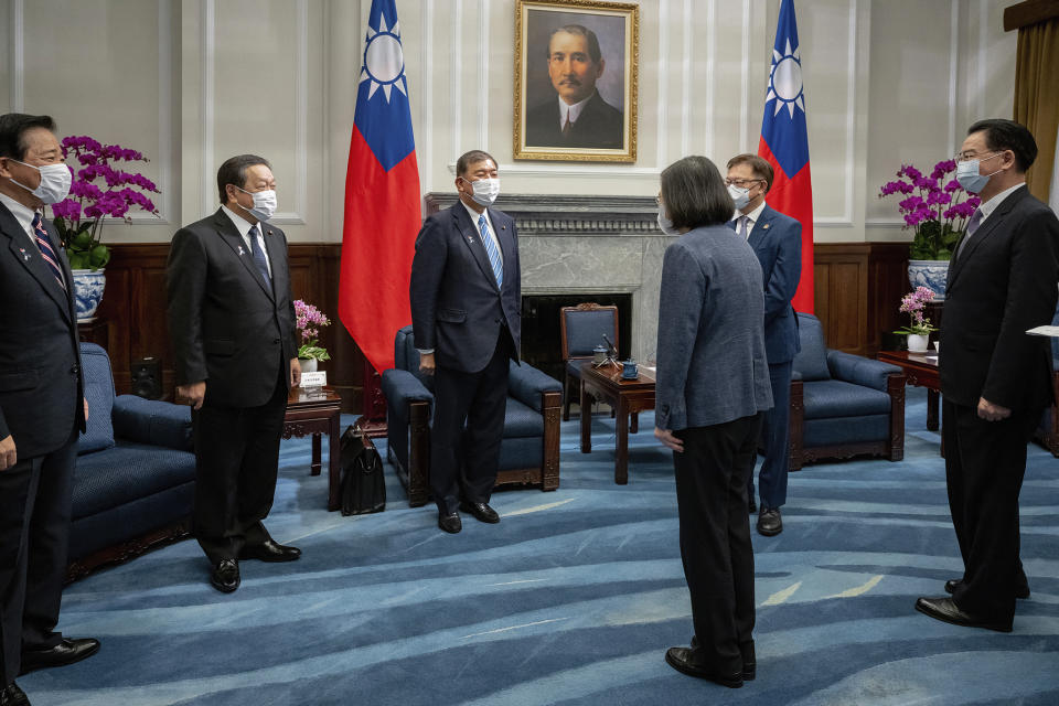 In this photo released by the Taiwan Presidential Office, Taiwan's President Tsai Ing-wen, third right, greets Japanese delegation led by lawmaker and former Defense Minister Shigeru Ishiba, third from left, at the presidential office in Taipei, Taiwan Thursday, July 28, 2022. The group of Japanese lawmakers including two former defense ministers met with Taiwan's president on Thursday in a rare high-level visit to discuss regional security. (Taiwan Presidential Office via AP)