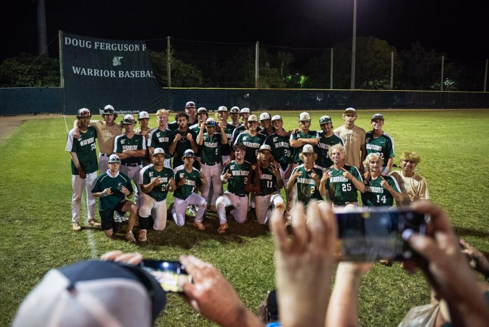 The Jupiter Warriors boy's baseball team poses for a picture after the end of the District 11-7A championship baseball game between host Jupiter and Palm Beach Central on Thursday, May 4, 2023, in Jupiter, Fla. Final score, Jupiter, 11, Palm Beach Central, 3.