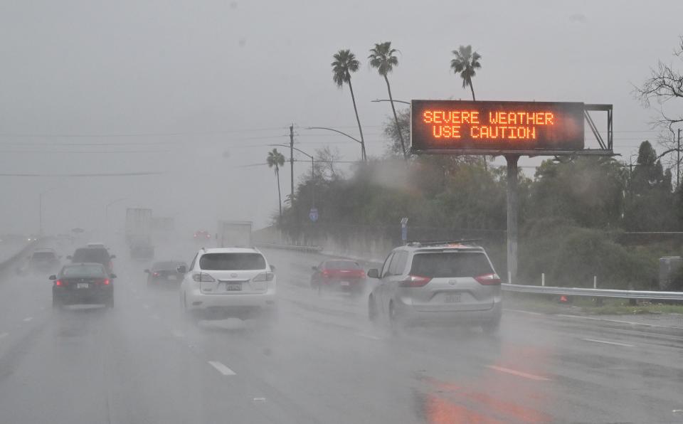 A sign on a Los Angeles freeway reminds drivers to use caution while driving in severe weather conditions on Feb. 6, 2024, as parts of Southern California experience record rainfall.