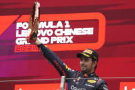 Third placed Red Bull driver Sergio Perez of Mexico celebrates on the podium after the Chinese Formula One Grand Prix at the Shanghai International Circuit, Shanghai, China, Sunday, April 21, 2024. (AP Photo/Andy Wong)