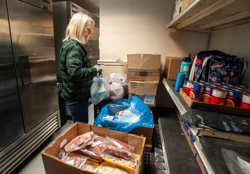Suzy Fontano, a Framingham resident who volunteers at the Pearl Street Cupboard & Cafe at Park, bags frozen goods, March 22, 2024.