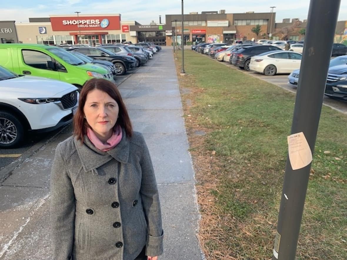 Alura Moores, of the Rosewood Community Association, says the parking lot at Woodside Square plaza is used for much more than just parking cars.  (Mike Smee/CBC - image credit)