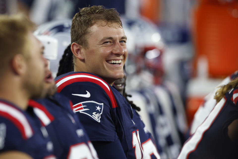 New England Patriots quarterback Mac Jones smiles while sitting on the bench during the first half of the team's NFL preseason football game against the Houston Texans, Thursday, Aug. 10, 2023, in Foxborough, Mass. (AP Photo/Michael Dwyer)