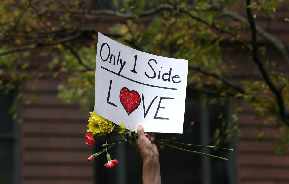 A demonstrator holds a banner reading "Only 1&nbsp;Side Love" during a protest at Federal Plaza Square in Chicago on Aug. 13.