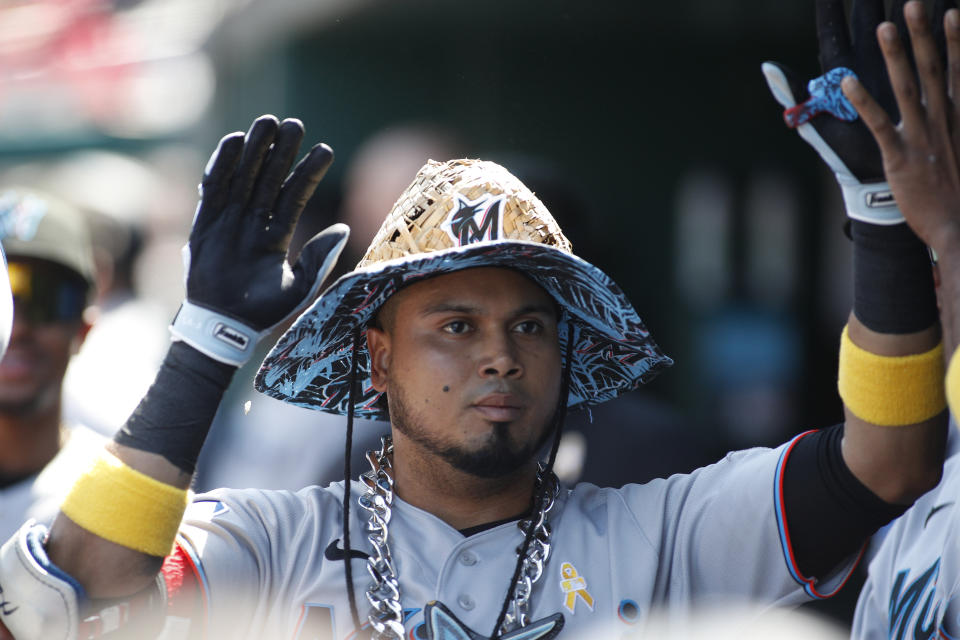 Miami Marlins' Luis Arraez celebrates with his teammates after hitting a solo home run during the first inning of a baseball game against the Washington Nationals, Sunday, Sept. 3, 2023, in Washington. (AP Photo/Luis M. Alvarez)