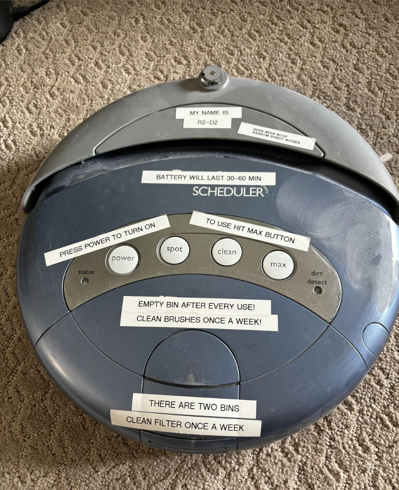 Reddit post showing a vacuum robot with multiple labels explaining its usage and functionality. The post's title humorously notes it as a 'robot mop-man.'