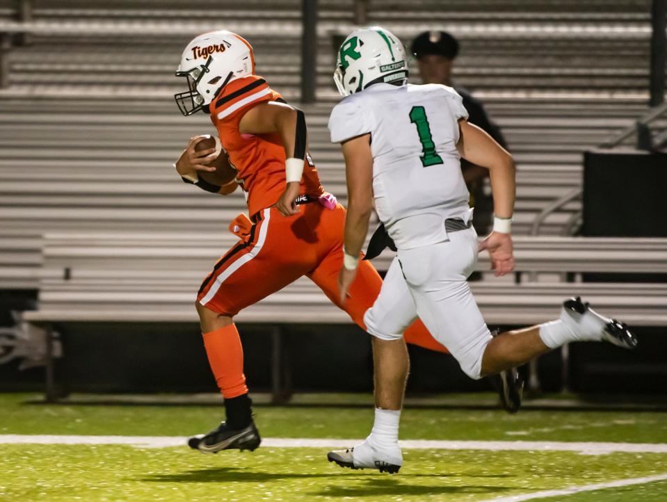 Riverside's Sam Hughes can't quite catch up to Beaver Falls QB Jaren Brickner, who held the ball and took it in for the Tigers last score during their game Friday at Reeves Stadium. [Lucy Schaly/For BCT]