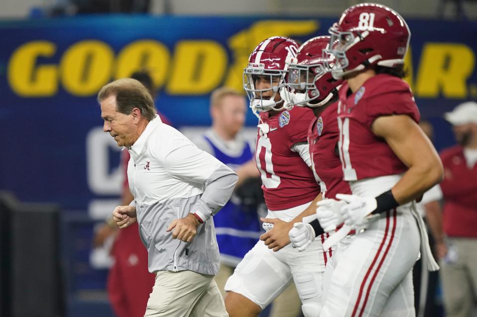 Alabama head coach Nick Saban leads his players onto the field at AT&T Stadium in Arlington for the College Football Playoff semifinals against Cincinnati on Dec. 31, 2021. The Crimson Tide won 27-6. The Cotton Bowl will host one of the two semifinals for the first 12-team CFP field in 2024.