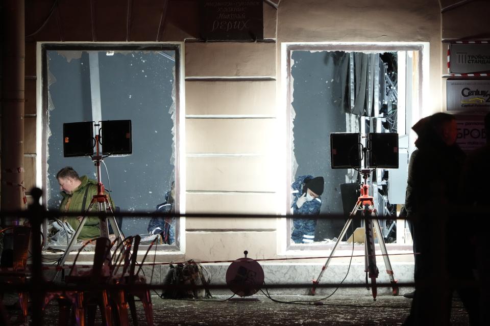 Russian investigators work at the site of an explosion at a cafe in St. Petersburg, Russia, Sunday, April 2, 2023. An explosion tore through a cafe in the Russian city of St. Petersburg on Sunday, and preliminary reports suggested a prominent military blogger was killed and more than a dozen people were injured. (AP Photo)