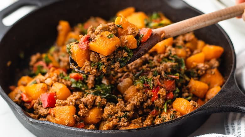 Butternut squash skillet being scooped on spoon