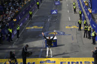 Former New England Patriots NFL football player Rob Gronkowski hoists the winner's trophy at the Boston Marathon, Monday, April 15, 2024, in Boston. Gronkowski is grand marshal of the race. (AP Photo/Charles Krupa)