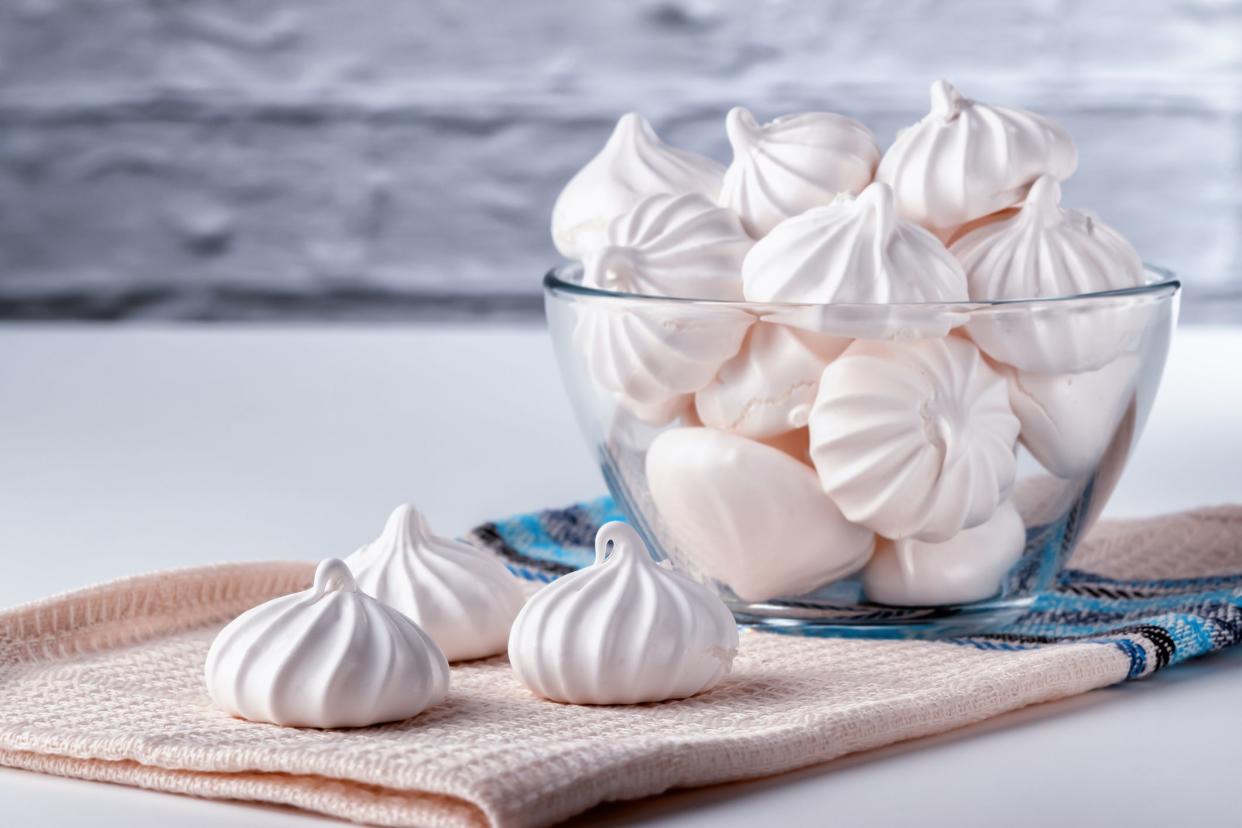 Sweet and airy bizet in a glass plate with a place for copyspace against the background of a white brick wall