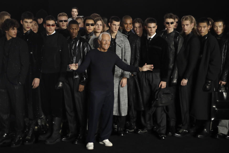 FILE - In this Saturday, Jan.11, 2019 file photo, designer Giorgio Armani, center, accepts applause at the conclusion of the Emporio Armani men's Fall-Winter 2020/21 collection, that was presented in Milan, Italy. Giorgio Armani, Fendi, Prada and Versace are all returning to the runway in September, according to the Milan Fashion Week calendar published on Wednesday, Aug. 12, 2020. After the coronavirus pushed many fashion houses to make on-line only presentations during the last fashion week in July, more than half of participating Milan fashion houses will hold physical shows to present previews for Spring-Summer 2021 in September. (AP Photo/Luca Bruno, File)