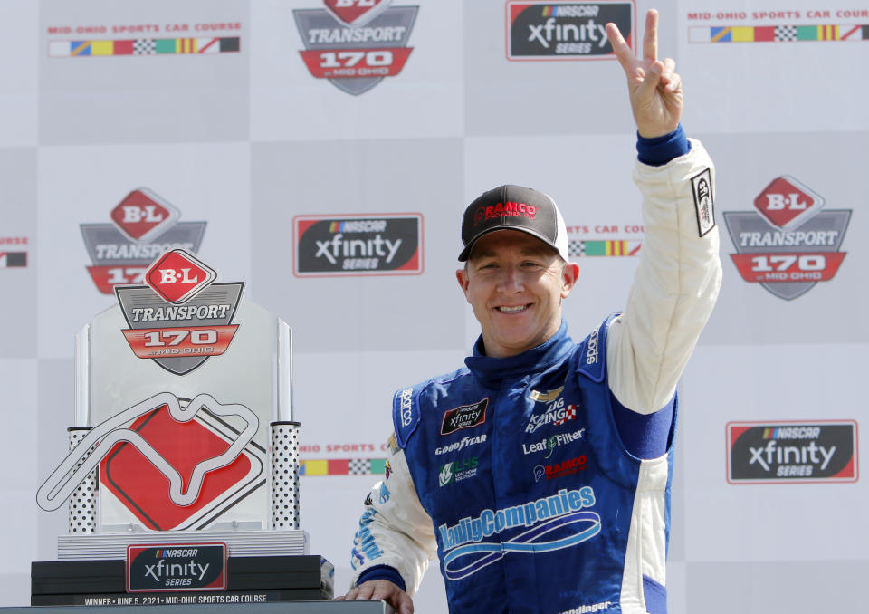 A.J. Allmendinger celebrates in Victory Lane after winning the B&L Transport 170 NASCAR Xfinity Series auto race at Mid-Ohio Sports Car Course on Saturday, June 5, 2021, in Lexington, Ohio. (AP Photo/Tom E. Puskar)