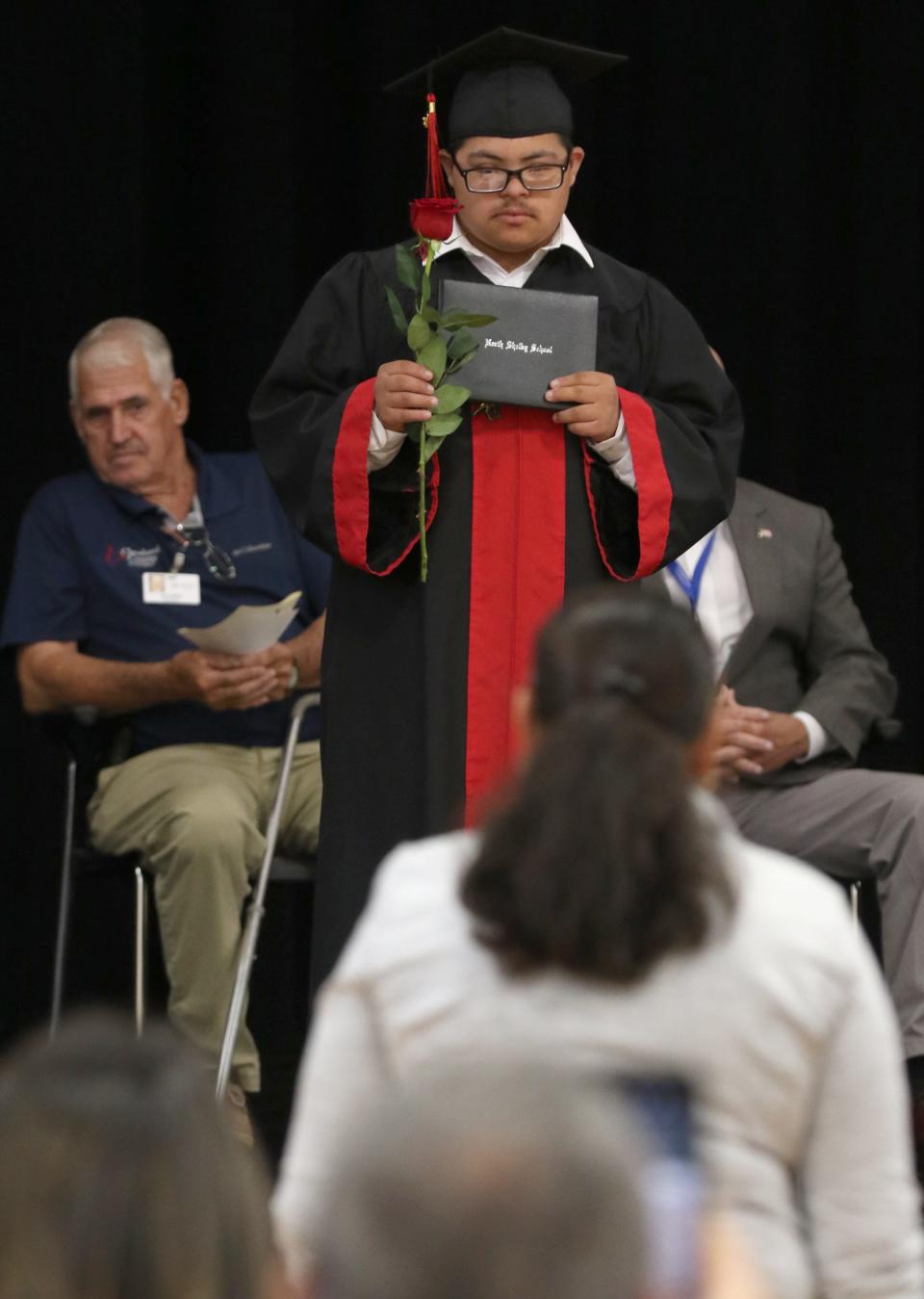 Julian Moreno-Lemus shows his certificate to his mother during the North Shelby Graduation Ceremony held Thursday morning, May 11, 2023, in the gym at North Shelby School.