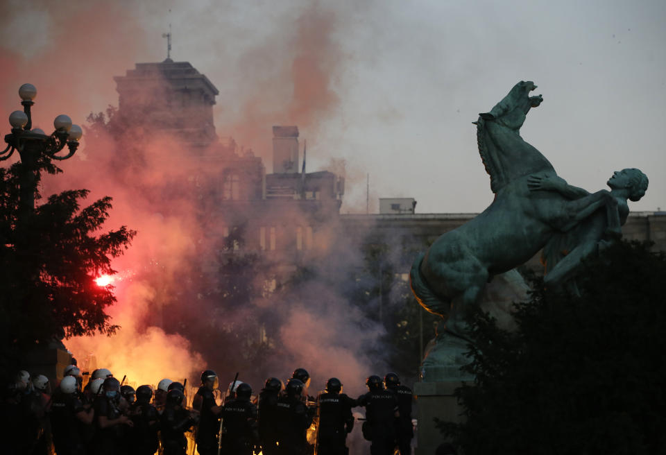 Serbian riot police clashes with protesters in Belgrade, Serbia, Wednesday, July 8, 2020. Serbia's president Aleksandar Vucic backtracked Wednesday on his plans to reinstate a coronavirus lockdown in Belgrade after thousands protested the move and violently clashed with the police in the capital. (AP Photo/Darko Vojinovic)