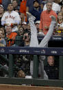 Boston Red Sox first baseman Steve Pearce fall into the dugout trying to catch a foul ball hit by Houston Astros' Josh Reddick during the seventh inning in Game 4 of a baseball American League Championship Series on Wednesday, Oct. 17, 2018, in Houston. (AP Photo/Frank Franklin II)