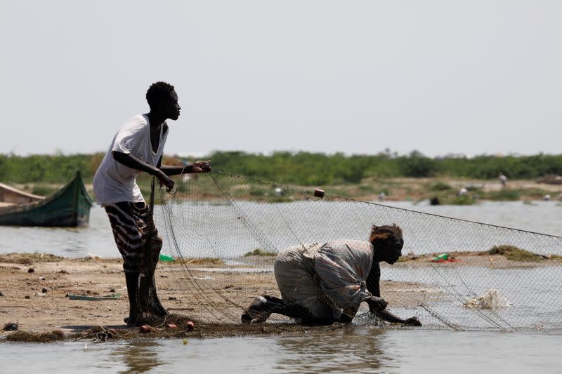 Women pull in a fishing net on a beach at Lake Turkana, near the town of Kalokol, Turkana county
