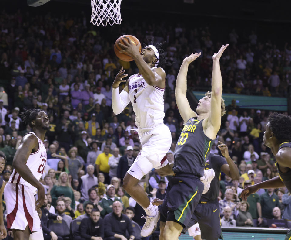 Arkansas guard Ricky Council IV (1) scores past Baylor forward Caleb Lohner (33) in the first half of an NCAA college basketball game, Saturday, Jan. 28, 2023, in Waco, Texas. (Rod Aydelotte/Waco Tribune-Herald via AP)