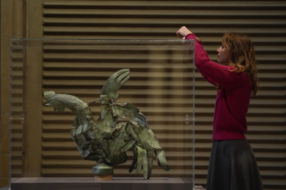 Curator in charge of the Galerie des moulages at the Cité de l'architecture et du patrimoine, Isabelle Marquette, places a glass panel around the rooster which sat atop of the spire of the Notre-Dame cathedral, in Paris, Friday, Dec. 15, 2023. Roosters are a symbol of France. The small bird that adorned Notre Dame plunged to the ground in the April 2019 fire that collapsed the spire and consumed the roof. (AP Photo/Thibault Camus)