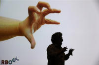 <p>An exhibitor is silhouetted against a screen as he presents its product in the Cube Tech Fair, in Berlin, Germany, May 10, 2017. Over 200 international startups showcase their innovative ideas and technologies to expert visitors and companies. (Photo: Felipe Trueba/EPA) </p>