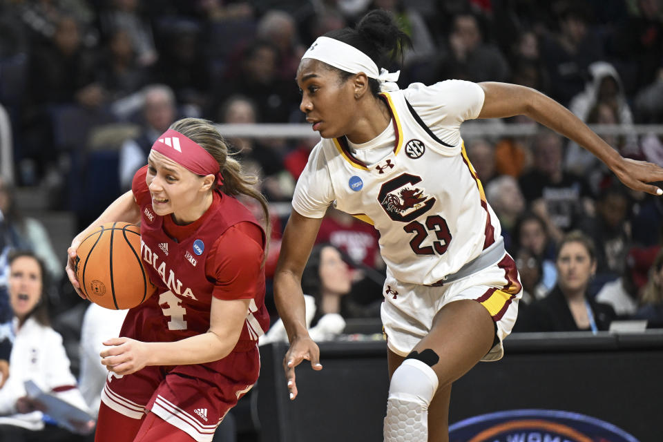 Indiana guard Sara Scalia (14) drives against South Carolina guard Bree Hall (23) during the first quarter of a Sweet Sixteen round college basketball game during the NCAA Tournament, Friday, March 29, 2024, in Albany, N.Y. (AP Photo/Hans Pennink)